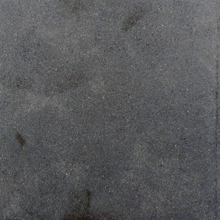 Color/Finish variation image for Ankar Black Basalt. The surface finish shown is honed. Dominant colors shown are black and gray; with black and purple secondaries. Exhibits "movement" and the color mix creates a cool feeling. Fine speckled, random and cloudy color patterns.