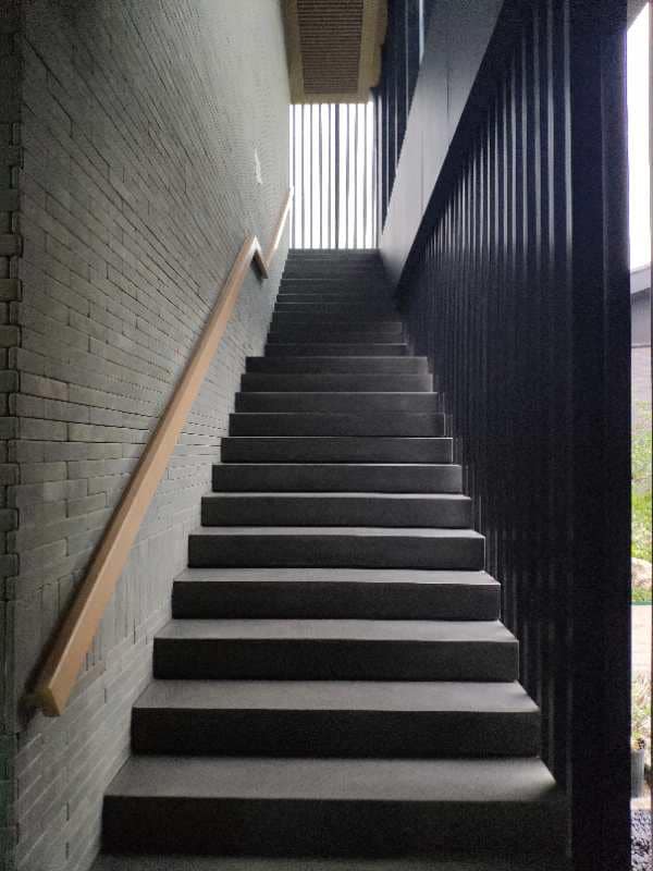 Application image for Ankar Black Basalt. The image shows this material being used in a monolithic steps application with a honed surface finish. This is a building and landscape stone for indoor and outdoor commercial and residential applications. Suitable for general use, freeze-thaw conditions, high traffic areas, low slipperiness surfaces and high heel compatibilty situations. Moderate to higher on the price spectrum.