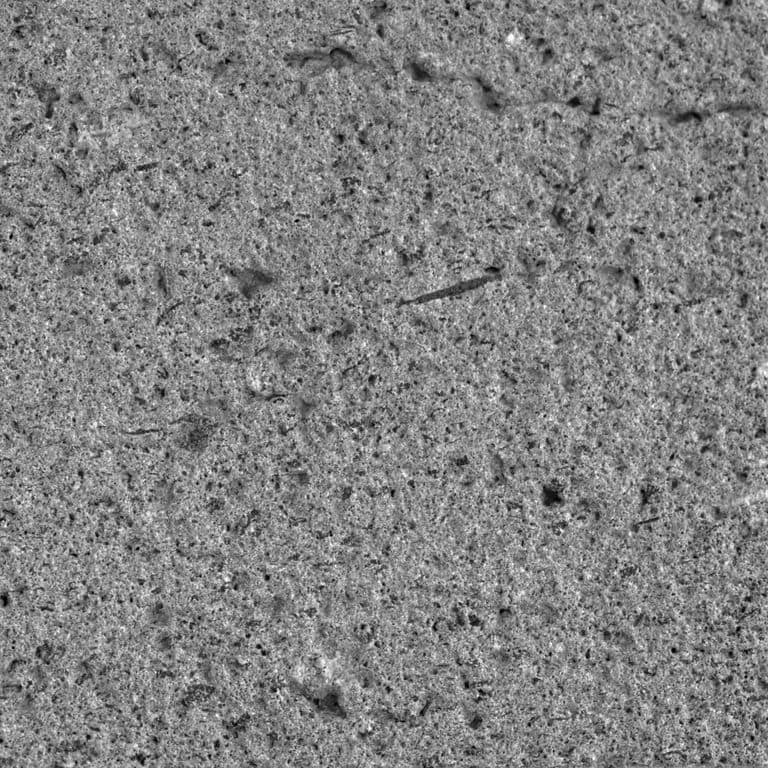 Color/Finish variation image for Basaltite. The surface finish shown is sand blasted. The dominant color shown is gray. The color mix creates a cool feeling. Regular and coarse speckled color patterns.