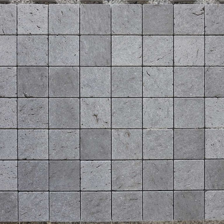 Application image for Basalt - Basaltite. The image shows this material being used for driveway pavers, path pavers and patio pavers. The surface finish shown is brushed. The dominant color shown is gray. Regular color pattern. Contains voids.