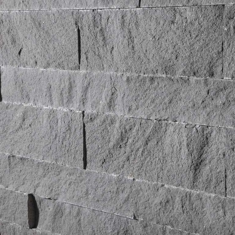 Application image for Basalt - Basaltite. The image shows this material being used for full bed veneer and thin veneer. The surface finish shown is split-face. The dominant color shown is gray. The color mix creates a cool feeling. Regular color pattern.