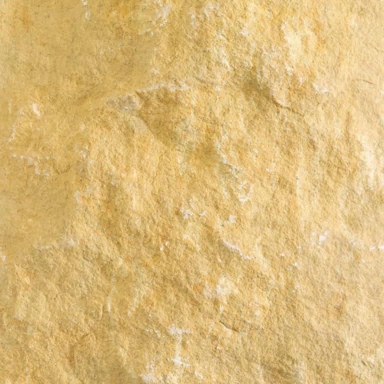Color/Finish variation image for Glacier Buff Limestone. The surface finish shown is split-face with rough plane. Dominant colors shown are orange/rust, yellow and tan; with beige and cream secondaries. The color mix creates a warm feeling. Blotched and swirled color patterns.