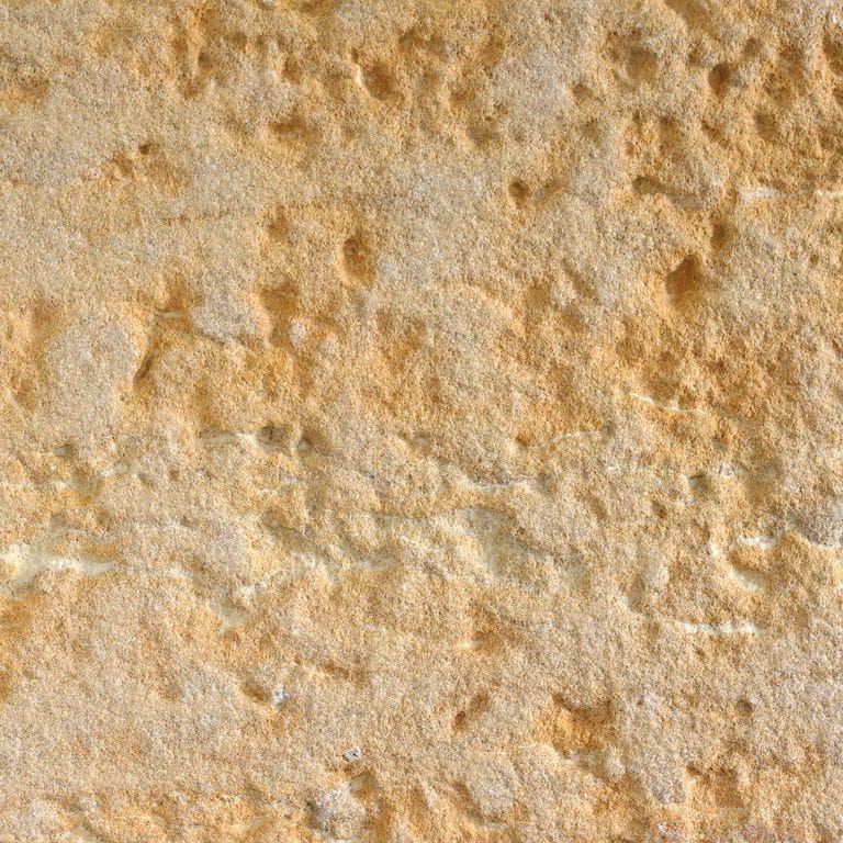 Feature image for Glacier Buff Limestone. Dominant colors shown are beige, orange/rust and tan; with brown, yellow and cream secondaries. Exhibits "movement" and the color mix creates a warm feeling. Random, blotched, veined and cloudy color patterns.