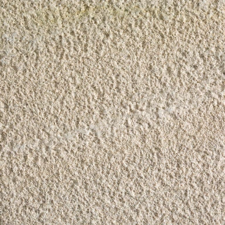 Feature image for Sterling Limestone. Dominant colors shown are beige and tan; with brown and cream secondaries. Exhibits "movement" and the color mix creates a warm feeling. Coarse speckled color pattern.
