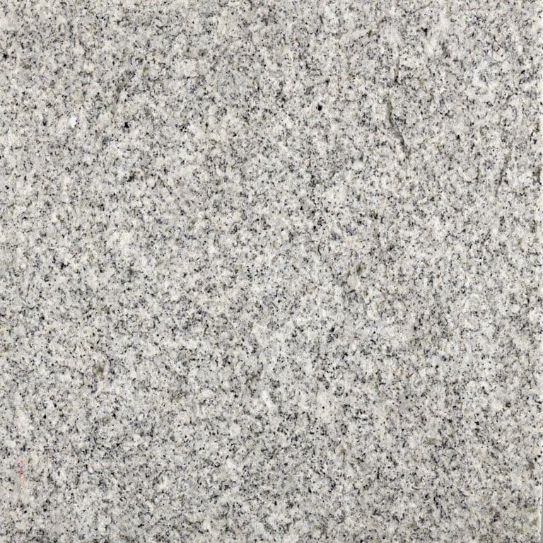 Feature image for Blue Sky Granite. Dominant colors shown are gray and white; with beige and cream secondaries. The color mix creates a cool feeling. Speckled and fine speckled color patterns. Contains some mica and mineral inclusions.