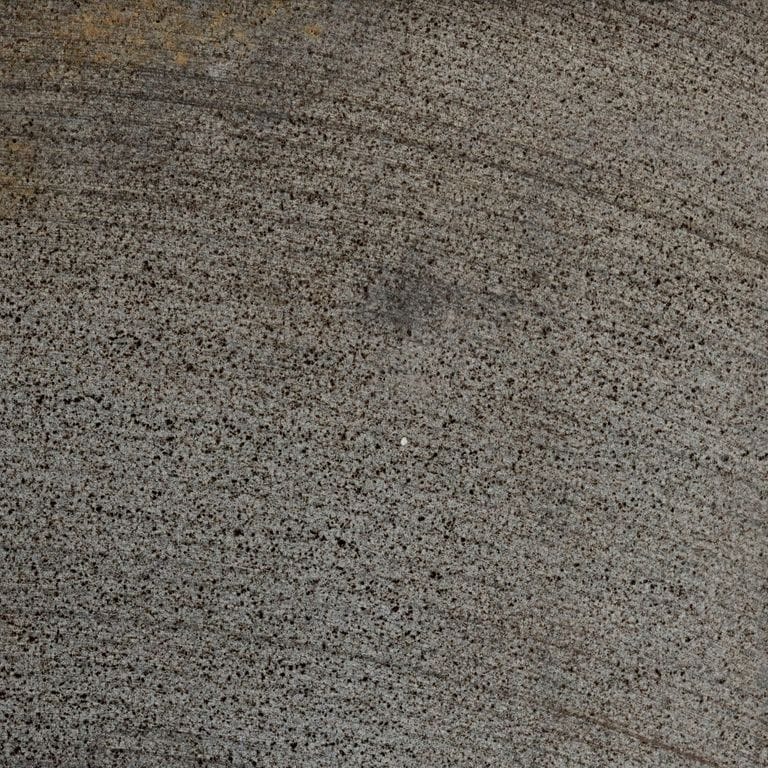 Feature image for Basalt - Ankar Black Microhole. The dominant color shown is gray; with green and purple secondaries. Exhibits "movement" and the color mix creates a warm feeling. Regular and fine speckled color patterns.