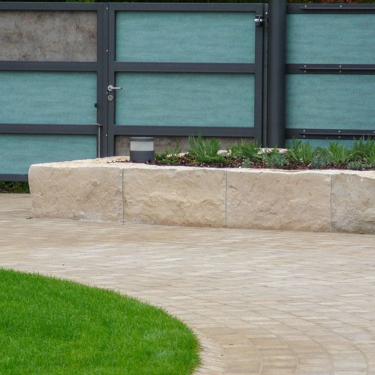 Application image for Bavarian Limestone Gala - Beige. The image shows this material being used in a landscape curbing &amp; edging application. This is a building and landscape stone for outdoor commercial and residential applications. Suitable for general use, low heat absorption surfaces, high traffic areas, low slipperiness surfaces and high heel compatibilty situations. Moderate to higher on the price spectrum.