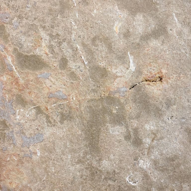 Color/Finish variation image for Bavarian Dolomite - Gray. The surface finish shown is flamed. The dominant color shown is tan; with beige, blue, brown, gray, orange/rust and cream secondaries. Exhibits "movement" and the color mix creates a warm feeling. Random color pattern. Contains voids and mineral inclusions.