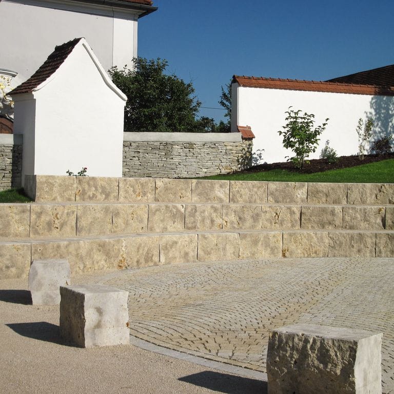 Application image for Bavarian Dolomite - Gray. The image shows this material being used in a monolithic steps application. This is a building and landscape stone for indoor and outdoor commercial and residential applications. Suitable for general use, freeze-thaw conditions, low heat absorption surfaces, high traffic areas and high heel compatibilty situations. Moderate to higher on the price spectrum.