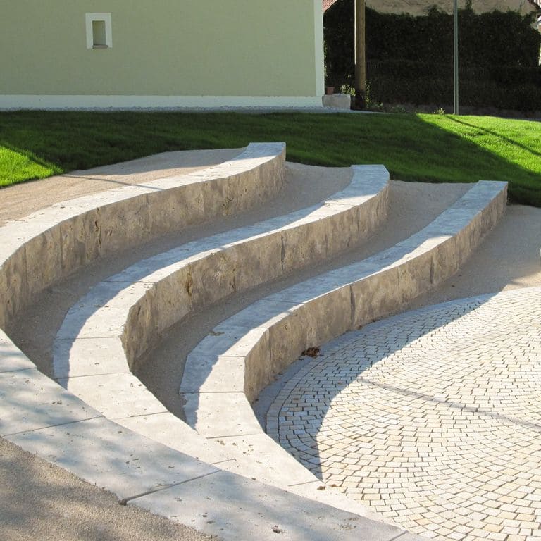 Application image for Bavarian Dolomite - Gray. The image shows this material being used in a monolithic steps application. This is a building and landscape stone for indoor and outdoor commercial and residential applications. Suitable for general use, freeze-thaw conditions, low heat absorption surfaces, high traffic areas and high heel compatibilty situations. Moderate to higher on the price spectrum.