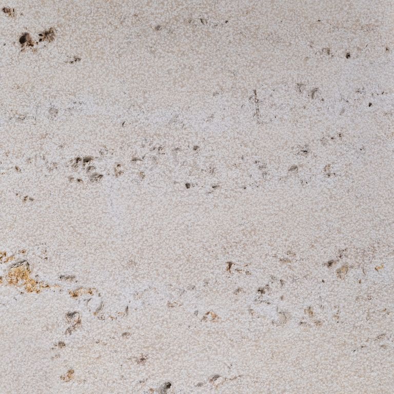 Color/Finish variation image for Bavarian Travertine - Beige. The surface finish shown is bush hammered. Dominant colors shown are beige and gray; with pink, purple and white secondaries. Exhibits "movement" and the color mix creates a warm feeling. Fine speckled, blotched and cloudy color patterns.