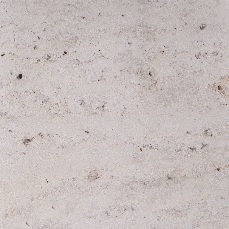 Color/Finish variation image for Bavarian Travertine - Beige. The surface finishes shown are brushed and sand blasted. Dominant colors shown are beige and gray; with pink, purple and white secondaries. Exhibits "movement" and the color mix creates a warm feeling. Cloudy color pattern.
