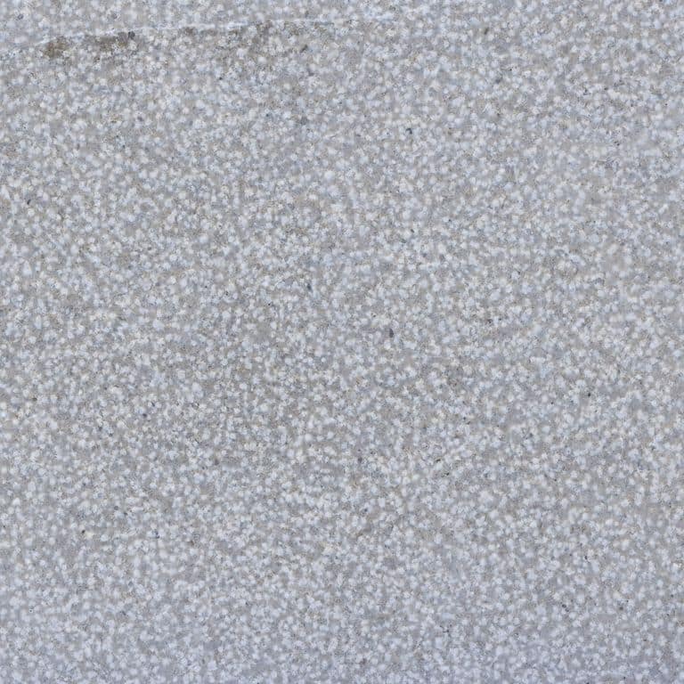 Color/Finish variation image for Blue Peak Limestone. The surface finishes shown are brushed and bush hammered. Dominant colors shown are blue, gray and white. The color mix creates a cool feeling. Coarse speckled color pattern.