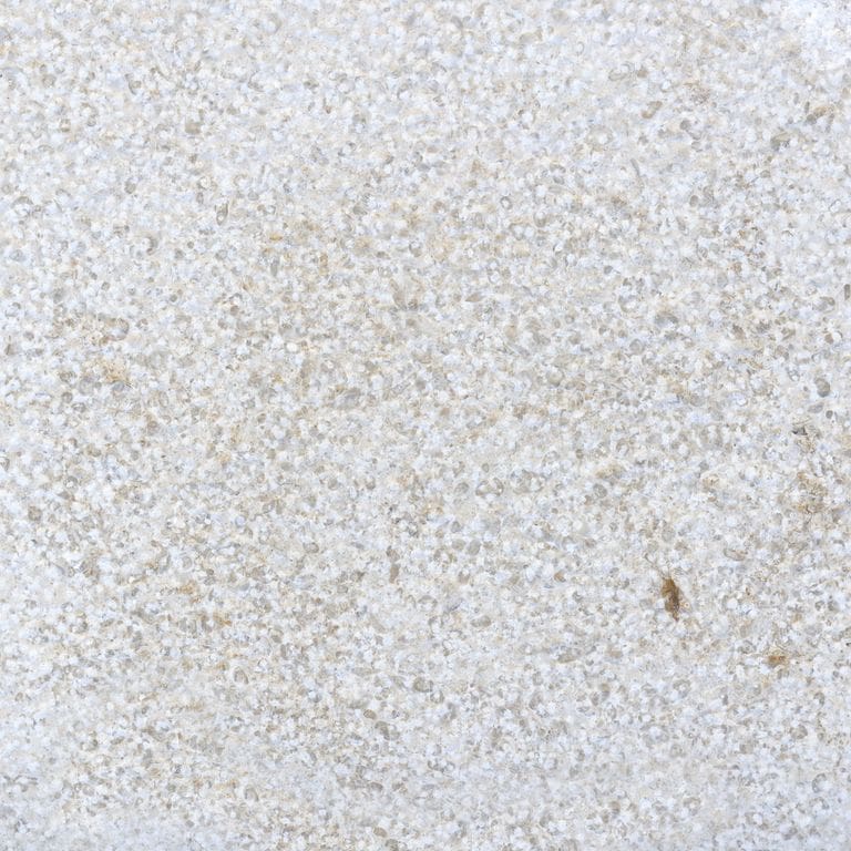 Color/Finish variation image for Sona Beige Limestone. The surface finish shown is bush hammered. Dominant colors shown are gray and white; with beige, pink and cream secondaries. The color mix creates a cool feeling. Coarse speckled and cloudy color patterns.