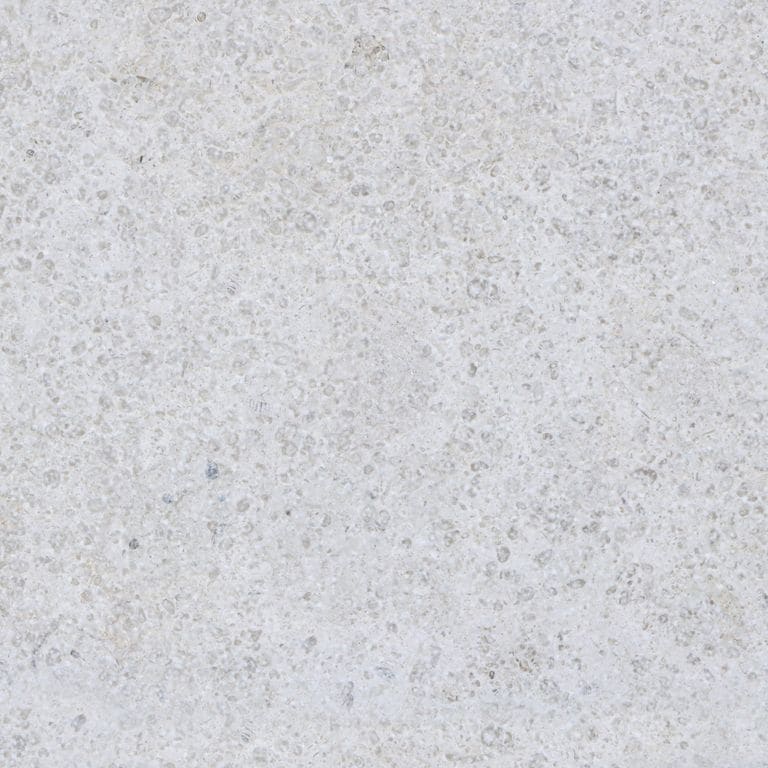 Color/Finish variation image for Sona Beige Limestone. The surface finishes shown are brushed and sand blasted. Dominant colors shown are gray and white; with beige and pink secondaries. The color mix creates a cool feeling. Speckled color pattern.