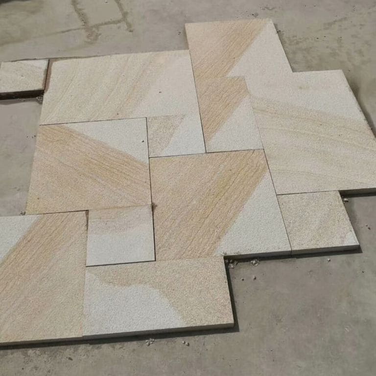 Close-up image for Yangtze Yellow Granite. The surface finishes shown are brushed and coarse bush hammered. Dominant colors shown are beige and gray; with brown, orange/rust, white and tan secondaries. Exhibits "movement" and the color mix creates a warm feeling. Fine speckled, linear and streaked color patterns.