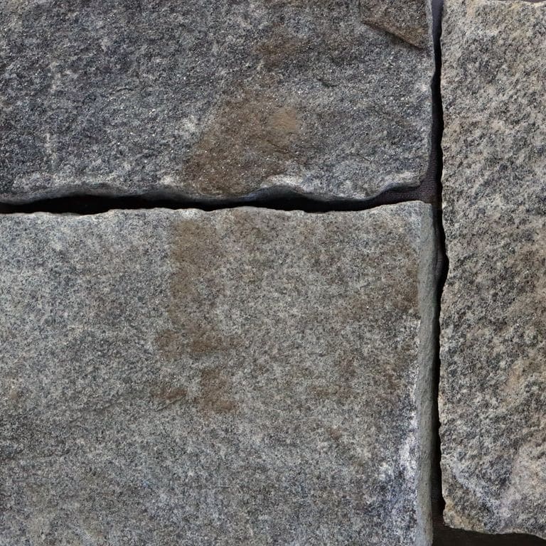 Best close-up image for Old Chester Granite. The image shows this material being used in a thin veneer application. The surface finish shown is . The dominant color shown is gray; with purple and white secondaries. Regular, linear and streaked color patterns. Contains some mica and mineral inclusions.