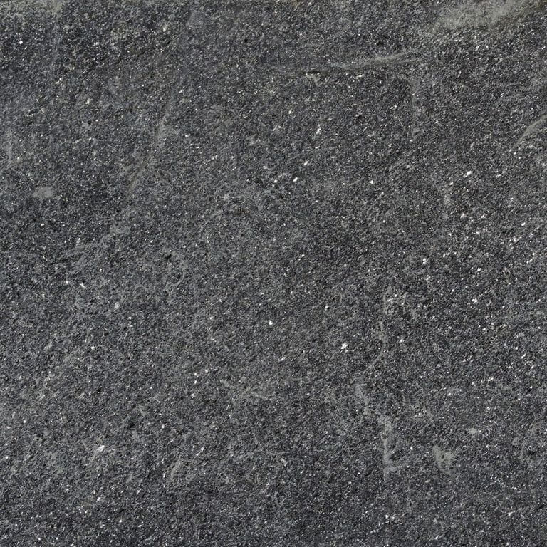 Swatch image cropped for Raven Hill Granite. The surface finish shown is split-face. Dominant colors shown are black and gray; with brown and green secondaries. Exhibits "movement" and the color mix creates a cool feeling. Fine speckled, blotched and cloudy color patterns. Contains lots of mica and mineral inclusions.
