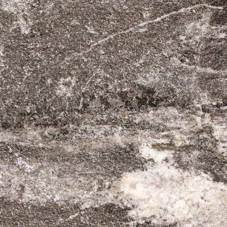 Color/Finish variation image for Raven Hill Granite. The surface finish shown is split-face. The dominant color shown is gray. Exhibits "movement". Veined and random color patterns. Contains some mica and mineral inclusions.