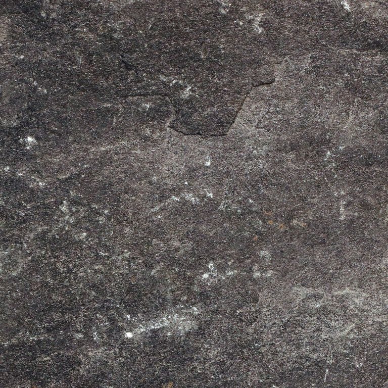 Color/Finish variation image for Raven Hill Granite. The surface finish shown is split-face. Dominant colors shown are black, brown and gray. The color mix creates a cool feeling. Regular color pattern. Contains some mica and mineral inclusions.