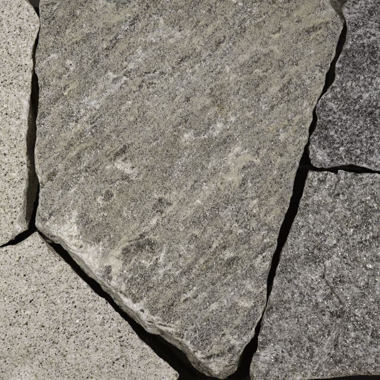 Close-up image for Castleton Granite. The dominant color shown is gray; with beige, brown, green, purple, white and tan secondaries. Exhibits "movement". Speckled, blotched, linear and streaked color patterns.