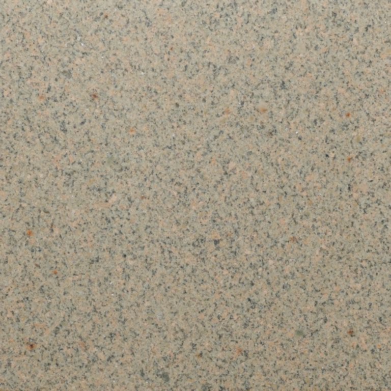 Feature image for Beige Granite. The surface finish shown is honed. Dominant colors shown are beige, brown and tan; with white, tan and cream secondaries. Exhibits "movement" and the color mix creates a warm feeling. Speckled and blotched color patterns.