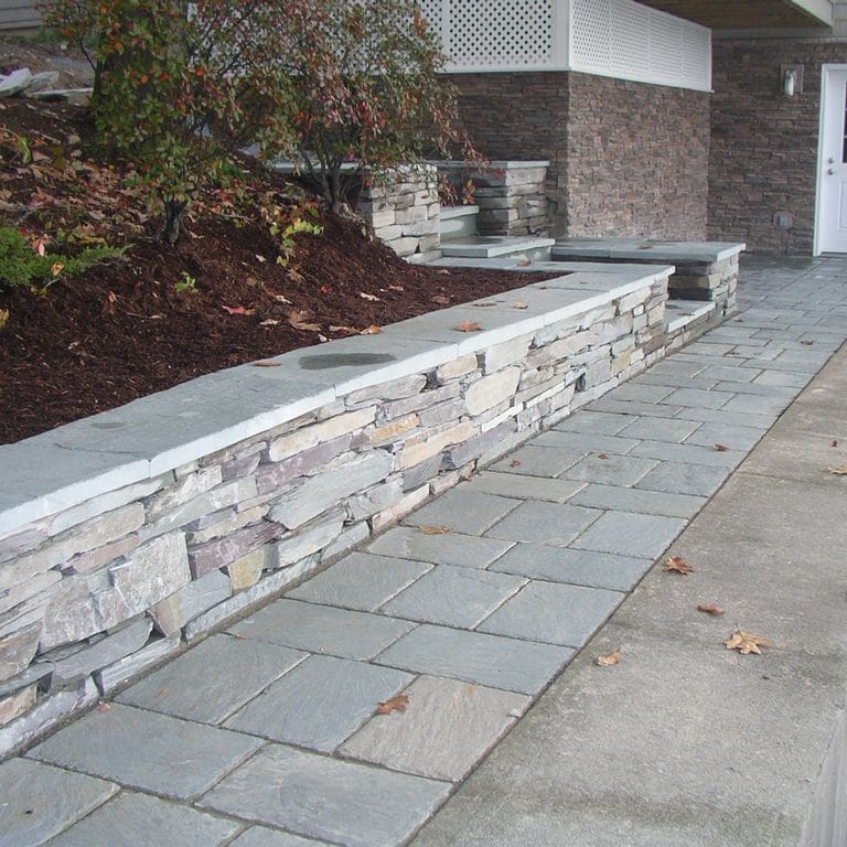 The image shows this material being used for wallstone cap and path pavers.