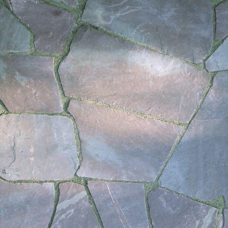 Close-up image for Vermont Slate - Mottled. The surface finish shown is natural cleft. Dominant colors shown are blue, gray and purple; with a green secondary. Exhibits "movement" and the color mix creates a cool feeling. Random and streaked color patterns.