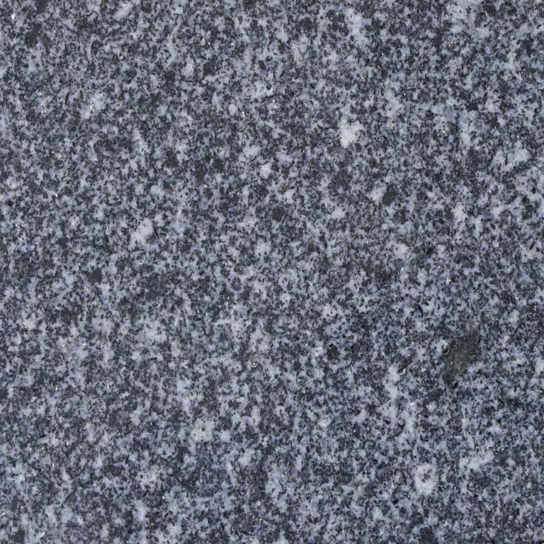Color/Finish variation image for Iberian Gray Granite. The surface finish shown is polished. Dominant colors shown are blue and gray; with black and purple secondaries. The color mix creates a cool feeling. Speckled and coarse speckled color patterns. Contains some mica and mineral inclusions.