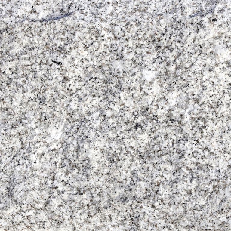 Close-up image for Iberian Gray Granite. The surface finish shown is split-face with flat plane. Dominant colors shown are gray and white. The color mix creates a cool feeling. Speckled color pattern. Contains some mica and mineral inclusions.
