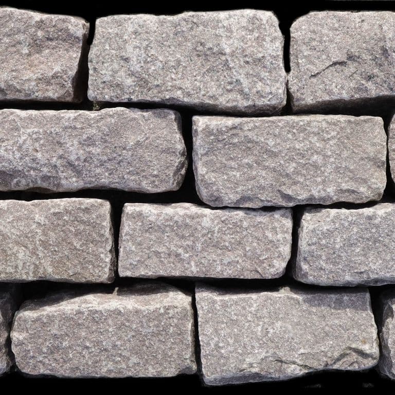 Feature image for Dusty Rose Granite Cobblestones. The dominant color shown is gray; with beige, pink and purple secondaries. Regular, fine speckled and cloudy color patterns. Contains some mica.