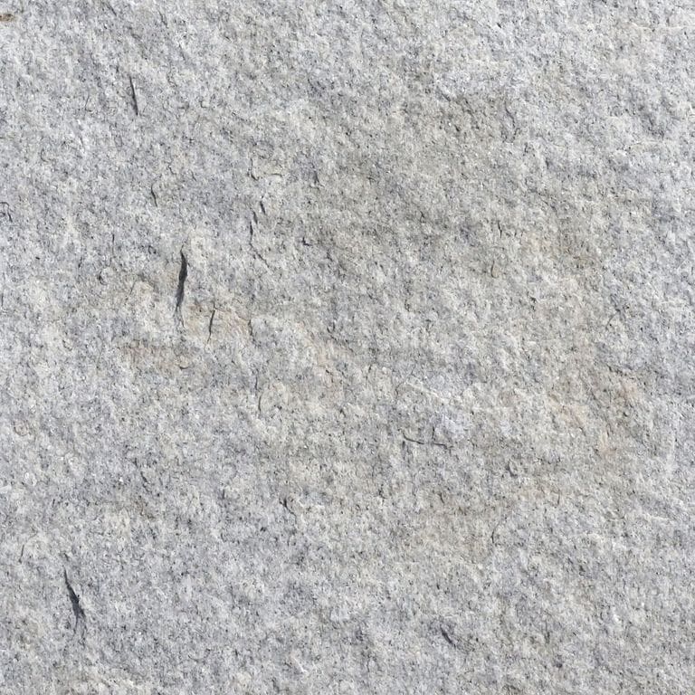 Color/Finish variation image for Granite Pavers - Square - Gray. The surface finishes shown are flamed and split-face with flat plane. Dominant colors shown are gray and white; with a beige secondary. The color mix creates a cool feeling. Fine speckled and cloudy color patterns.