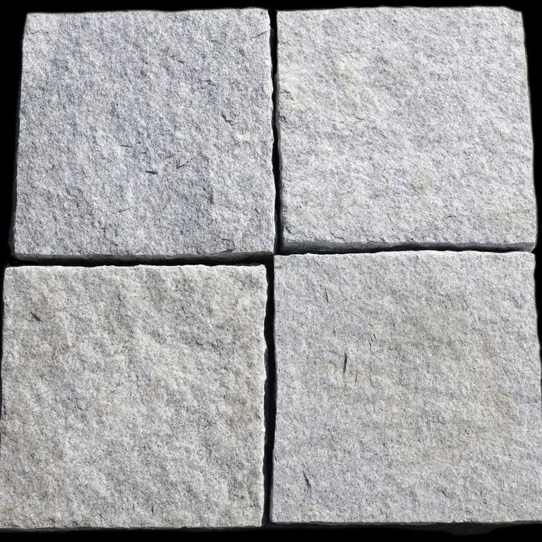 Best close-up image for Granite - Pavers - Square - Gray. The surface finish shown is split-face. Dominant colors shown are gray and white; with beige and white secondaries. The color mix creates a cool feeling. Regular and blotched color patterns. Contains some mica.