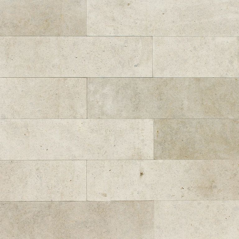 Best close-up image for Regent Buff Limestone. The image shows this material being used for full bed veneer and thin veneer. The surface finish shown is honed. Dominant colors shown are beige and cream; with gray, white and tan secondaries. The color mix creates a warm feeling. Regular and cloudy color patterns.
