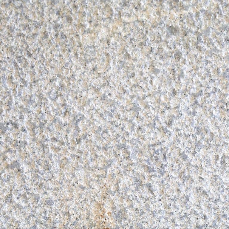 Color/Finish variation image for Granite - Atlantic. The surface finish shown is bush hammered. Dominant colors shown are gray and white; with beige, blue, tan and cream secondaries. The color mix creates a cool feeling. Coarse speckled color pattern.