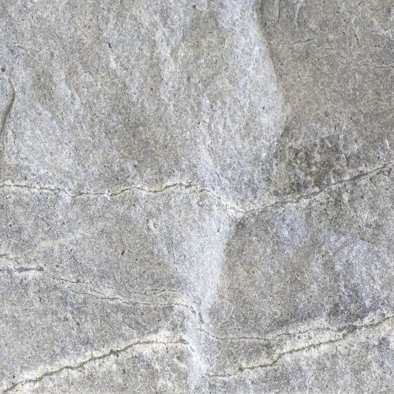 Feature image for Atlantic Granite. Dominant colors shown are gray and white; with beige, blue and cream secondaries. Exhibits "movement" and the color mix creates a cool feeling. Fine speckled, blotched, veined and cloudy color patterns. Contains mineral inclusions.