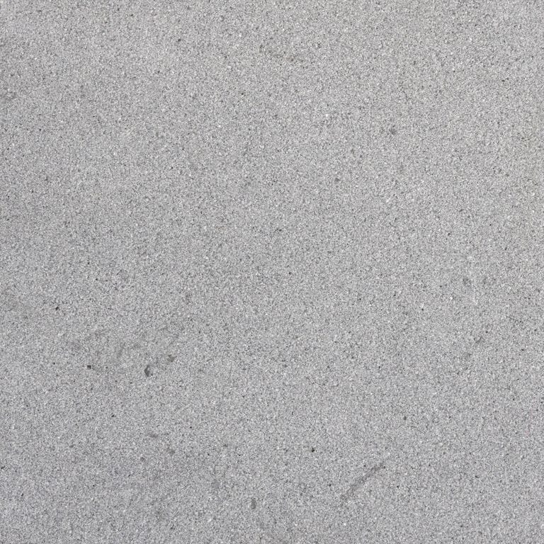 Color/Finish variation image for Polar Gray Limestone. The surface finish shown is sand blasted. The dominant color shown is gray. The color mix creates a cool feeling. Fine speckled and cloudy color patterns.