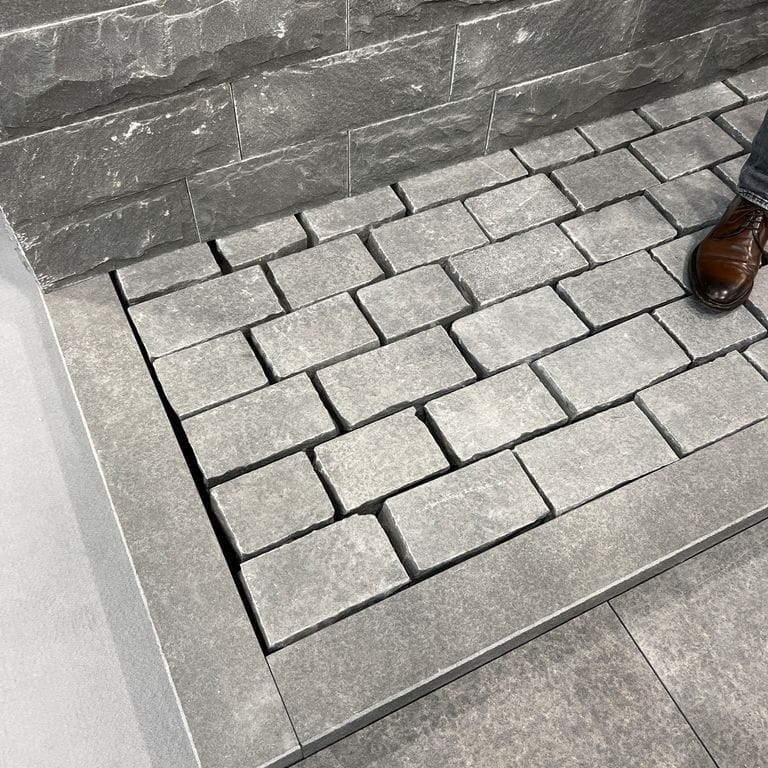 Application image for Polar Gray Limestone. The image shows this material being used in a path pavers application. The dominant color shown is gray. Regular color pattern.