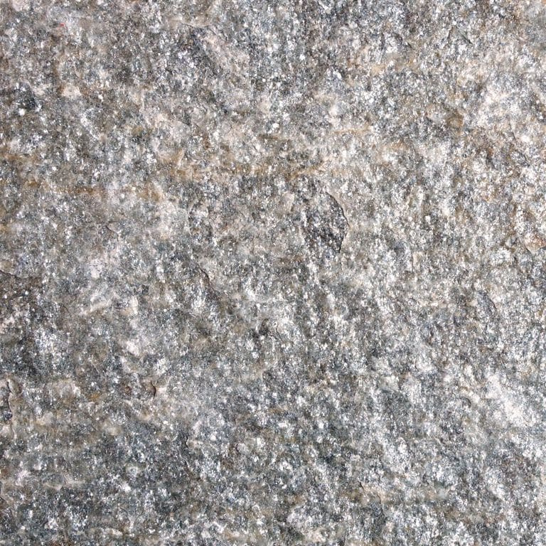 Color/Finish variation image for Pietra Italia Gneiss. The surface finish shown is natural cleft. The dominant color shown is gray; with beige, blue, brown, green, pink, purple, white, tan and cream secondaries. The color mix creates a cool feeling. Blotched color pattern. Contains lots of mica and mineral inclusions.