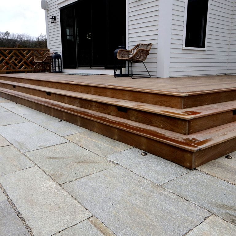 Application image for Pietra Italia Full Color Gneiss. The image shows this material being used in a patio pavers application. The surface finish shown is natural cleft. The dominant color shown is gray. The color mix creates a warm feeling. Contains some mica and mineral inclusions.