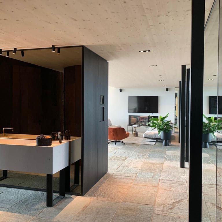 Application image for Pietra Italia Full Color Gneiss. The image shows this material being used in an interior floor application. The surface finish shown is natural cleft. Dominant colors shown are beige and tan; with beige and gray secondaries. The color mix creates a warm feeling. Regular color pattern.