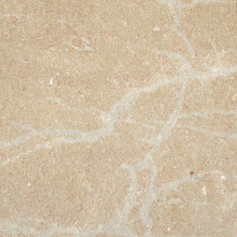 Color/Finish variation image for Cenia Beige Dolomitic Limestone. The surface finish shown is flamed. Dominant colors shown are beige and tan; with brown, orange/rust and cream secondaries. Exhibits "movement" and the color mix creates a warm feeling. Veined color pattern. Contains mineral inclusions.