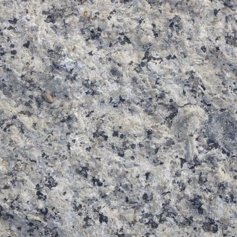 Color/Finish variation image for Reclaimed First Generation Granite Curbstone. The surface finishes shown are weathered and worn. The dominant color shown is gray; with beige, black, blue, green, purple and white secondaries. Exhibits "movement" and the color mix creates a cool feeling. Coarse speckled and blotched color patterns.