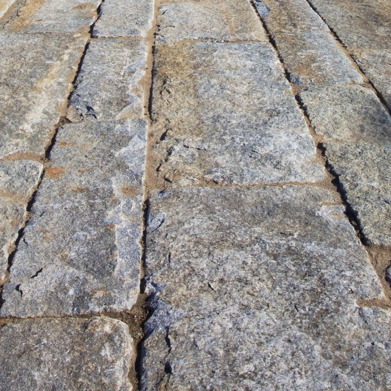 The surface finishes shown are split-face, weathered and worn. The dominant color shown is gray; with beige, blue, brown, green, orange/rust, purple, white and tan secondaries. Exhibits "movement". Speckled, blotched, swirled and cloudy color patterns. Contains lots of mica.