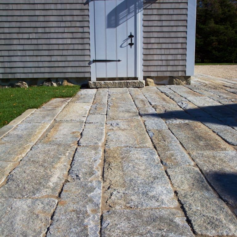 The image shows this material being used for path pavers and patio pavers. The dominant color shown is gray; with beige, blue, brown and orange/rust secondaries.