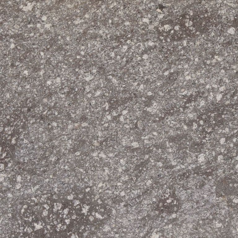 Swatch image cropped for Imperial Roman Porphyry - Brown. The surface finish shown is sawn. Dominant colors shown are gray and purple; with beige, brown, green, white and tan secondaries. Exhibits "movement" and the color mix creates a cool feeling. Regular, coarse speckled and blotched color patterns.