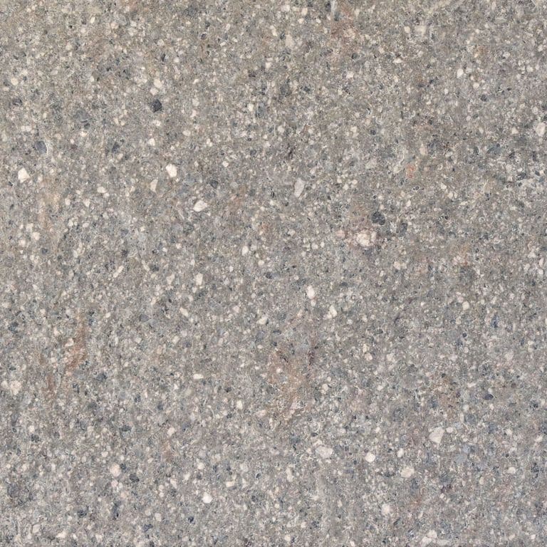 Close-up image for Imperial Roman Porphyry - Gray. The surface finishes shown are brushed and flamed. The dominant color shown is gray; with beige, blue, green, orange/rust, purple, white, tan and cream secondaries. Speckled and coarse speckled color patterns. Contains mineral inclusions.