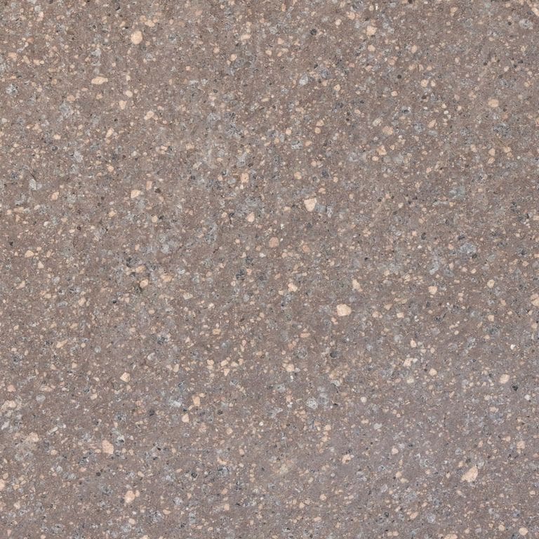 Close-up image for Imperial Roman Porphyry - Red. The surface finishes shown are brushed and flamed. Dominant colors shown are gray and purple; with beige, brown, green, orange/rust and tan secondaries. The color mix creates a warm feeling. Speckled and coarse speckled color patterns.
