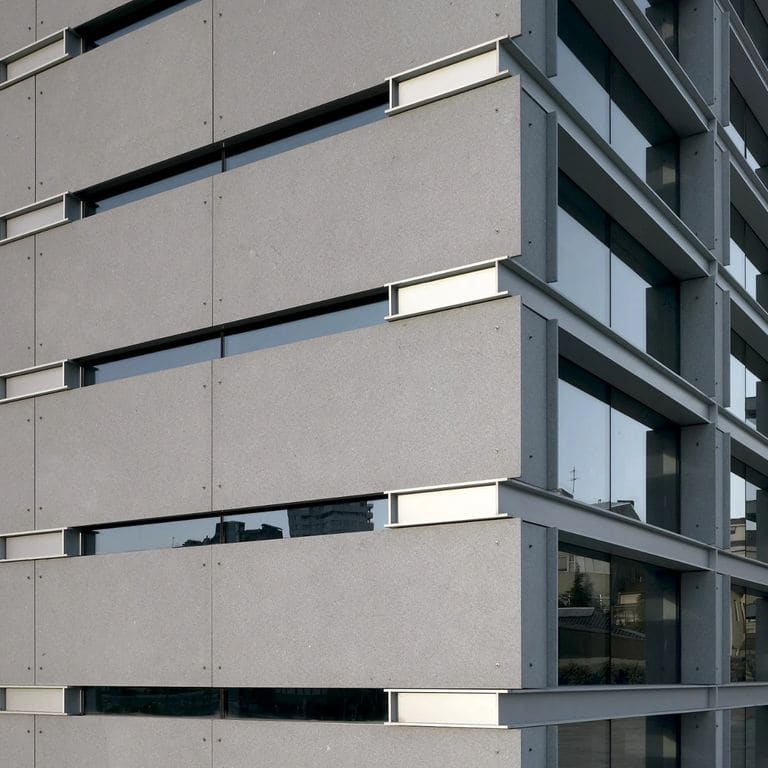 Feature image for Gray Nisa Granite. The image shows this material being used in a full bed veneer application. The dominant color shown is gray; with a white secondary. The color mix creates a cool feeling. Fine speckled color pattern.
