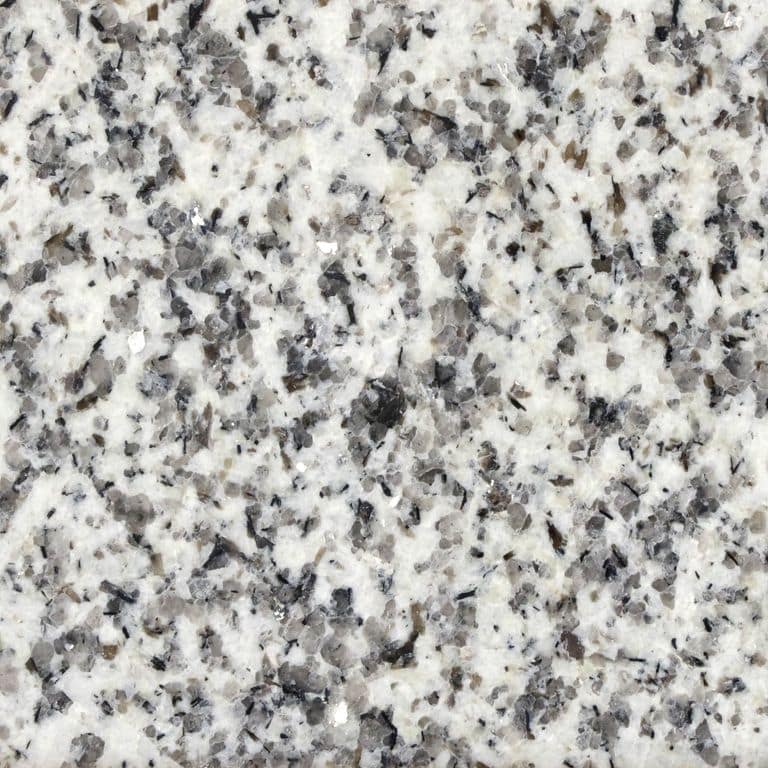 Color/Finish variation image for Crystal White Granite. The surface finish shown is polished. Dominant colors shown are gray and white; with beige and cream secondaries. The color mix creates a cool feeling. Coarse speckled color pattern.